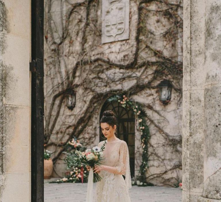 Bride in Lace Wedding Dress Holding Her Anemone Wedding Bouquet