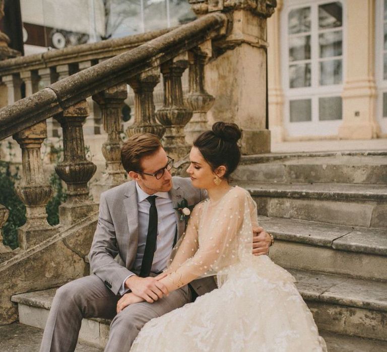 Bride and Groom Embracing on the Steps of Finca Torrefiel Wedding Venue