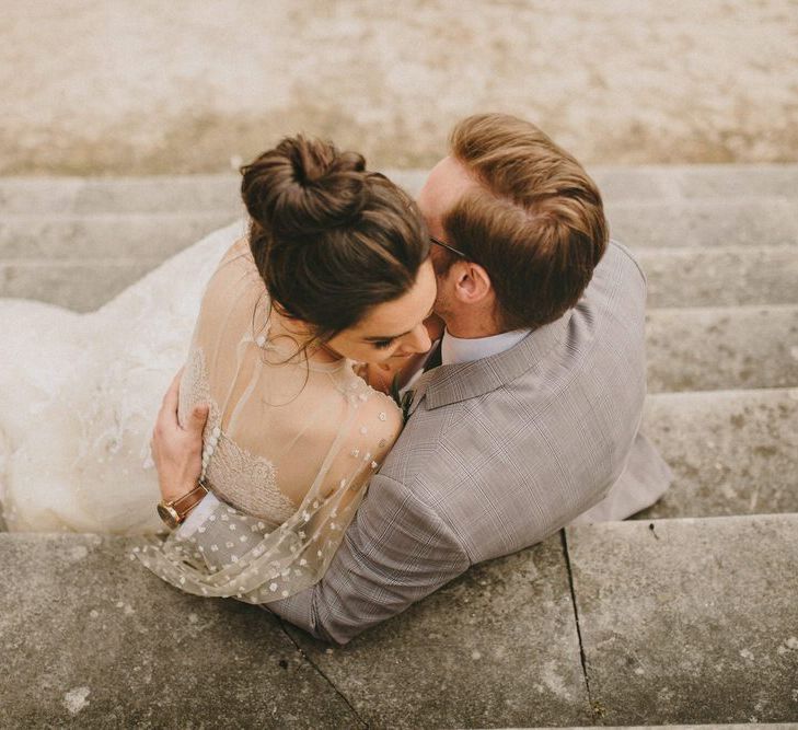 Bride and Groom Embracing on the Steps