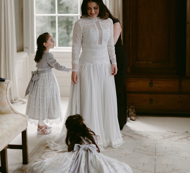 Bride in Homemade Wedding Dress with Lace Long Sleeves and High Neck Getting Ready