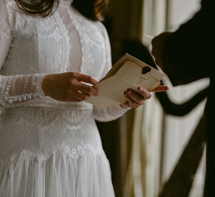 Bride in Homemade Wedding Dress with Lace Bodice and Long Sleeves Saying Her Vows