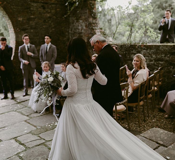 Bride Walking Down the Aisle in a Homemade Wedding Dress with Lace Bodice and Long Sleeves