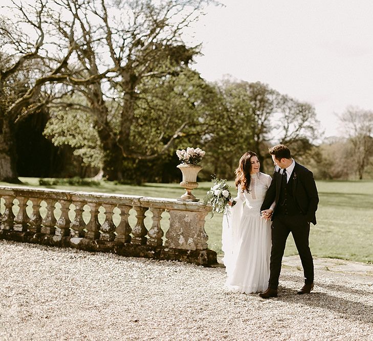 Bride in Homemade Wedding Dress with Long Sleeves and Groom in Zara Suit