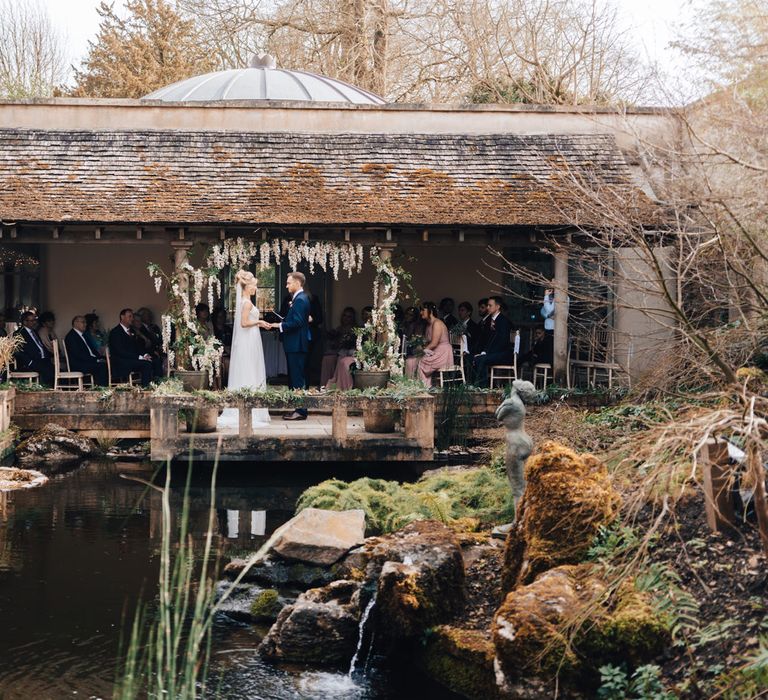 Outdoor Wedding Ceremony with Bride in Stacey by Modeca Wedding Dress and Groom in  Charles Tyrwhitt Suit