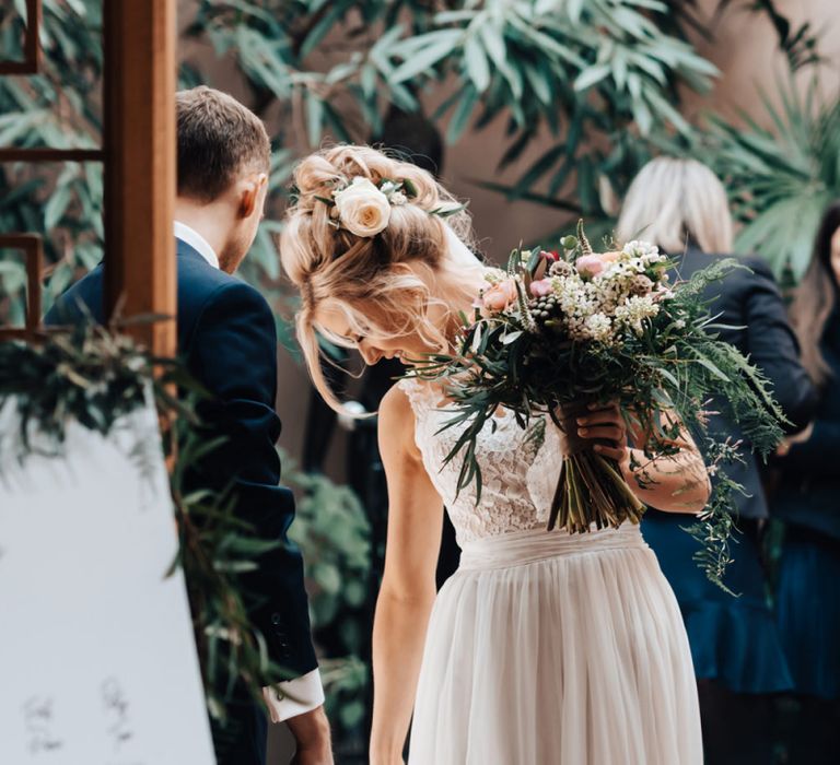 Bride in Stacey by Modeca Wedding Dress Holding Wedding Bouquet