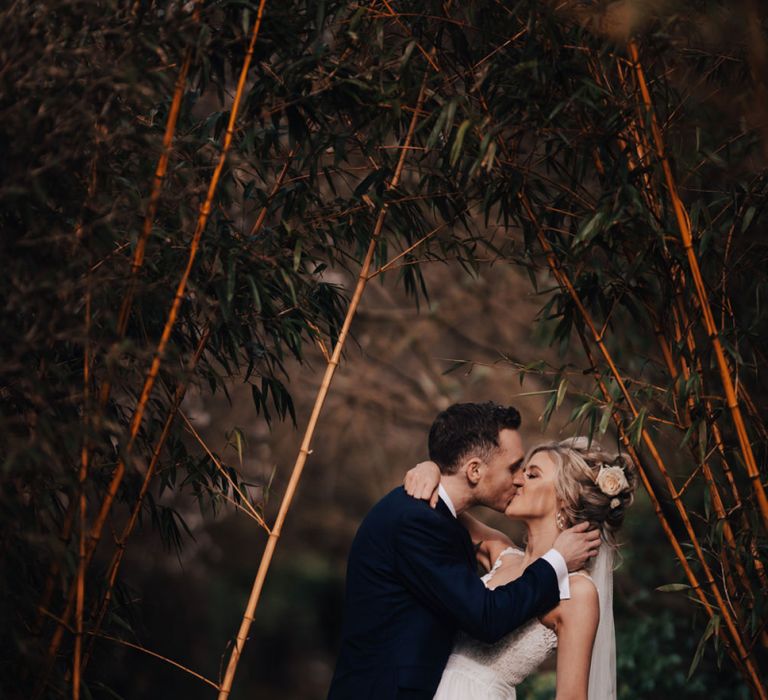 Bride in Stacey by Modeca Wedding Dress and Groom  in Charles Tyrwhitt Suit Kissing