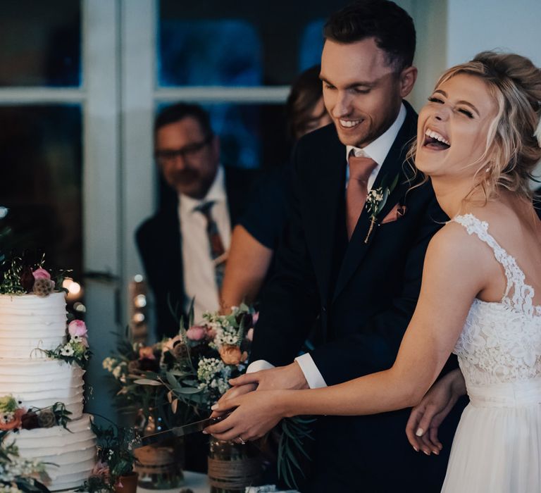 Bride and Groom Cutting the Wedding Cake