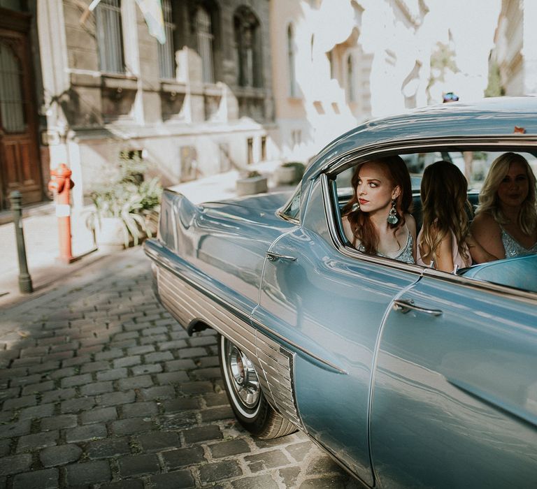 Vintage Blue Cadillac Wedding Car | Bridesmaids in Blue Drop Waist Dresses with Spaghetti Straps and Beading | Bridesmaids in Pink V-Neck Dresses | Budapest Wedding with Giant Bridal Bouquet, Tuk Tuks and Cadillac | Jágity Fanni Fotográfus