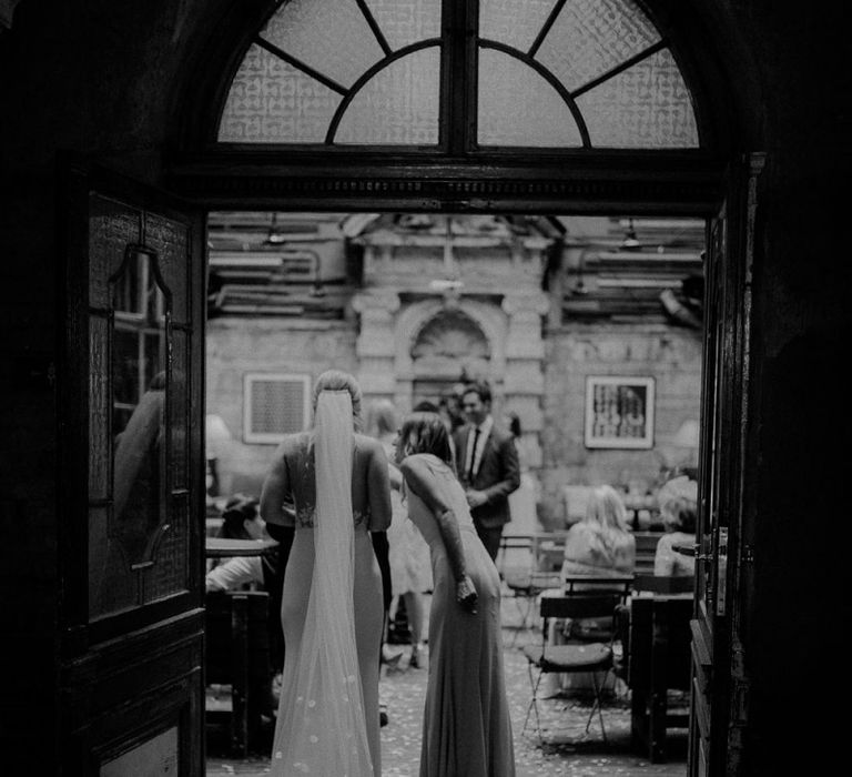 Bride in Lila Gown by Alexandra Grecco with Fitted Silk Crepe Skirt and Sheer Italian Tulle Bodice Covered in Floral Lace Applique | Theia Bridal Veil with Petal Detail | Wedding Reception at Brody Studios | Budapest Wedding with Giant Bridal Bouquet, Tuk Tuks and Cadillac | Jágity Fanni Fotográfus