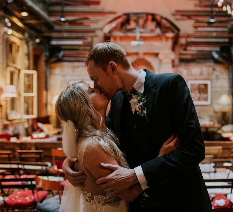 Bride in Lila Gown by Alexandra Grecco with Fitted Silk Crepe Skirt and Sheer Italian Tulle Bodice Covered in Floral Lace Applique | Theia Bridal Veil with Petal Detail | Groom in Black Three-Piece Suit from Hackett with Burgundy Bow Tie from Zara | Brody Studios, Budapest, Hungary | Budapest Wedding with Giant Bridal Bouquet, Tuk Tuks and Cadillac | Jágity Fanni Fotográfus