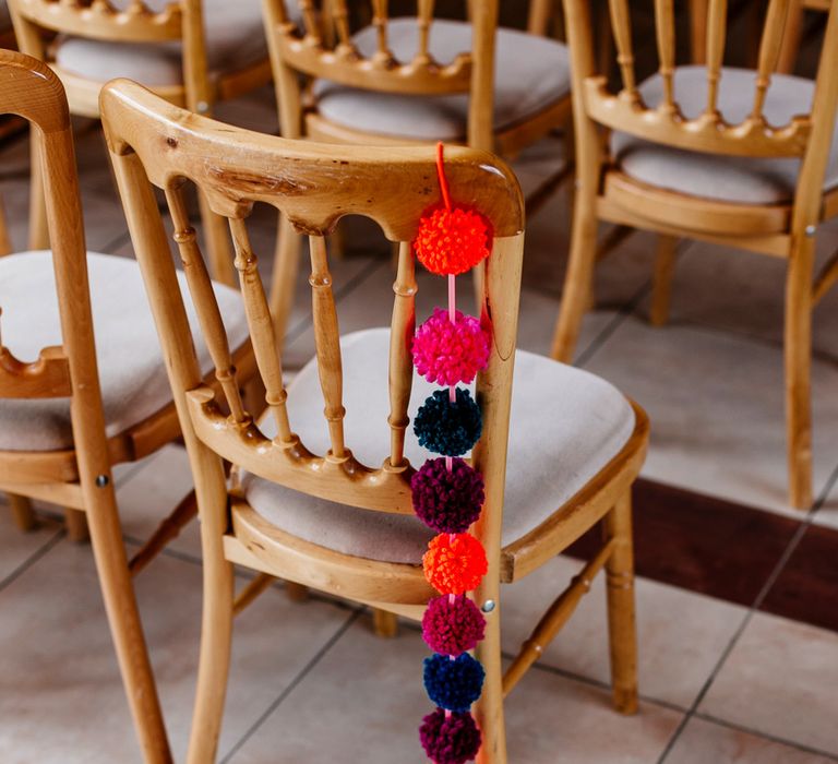 Pom Pom Chair Back Decor | Colourful Alternative Winter Wedding at Upwaltham Barns, Sussex | Epic Love Story Photography