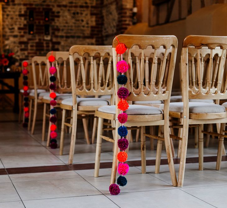 Pom Pom Chair Back Decor | Colourful Alternative Winter Wedding at Upwaltham Barns, Sussex | Epic Love Story Photography