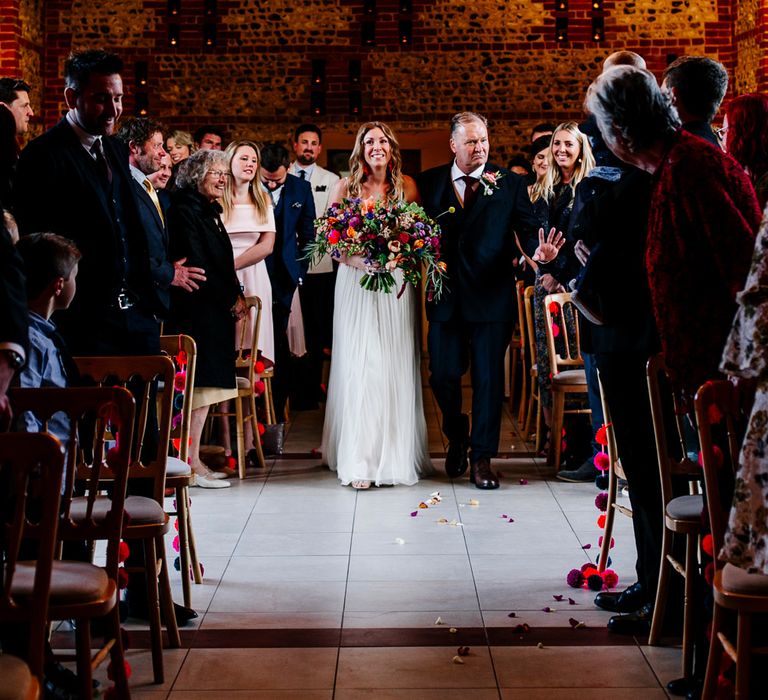 Wedding Ceremony | Bridal Entrance in Red &amp; White Joanne Fleming Design Wedding Dress | Colourful Alternative Winter Wedding at Upwaltham Barns, Sussex | Epic Love Story Photography