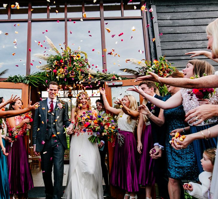 Confetti Moment |  Bride in Red &amp; White Joanne Fleming Design Wedding Dress | Groom in Suit Supply | Colourful Alternative Winter Wedding at Upwaltham Barns, Sussex | Epic Love Story Photography