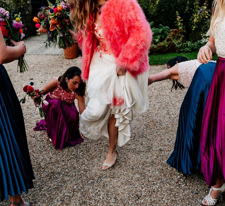 Bride in Red &amp; White Joanne Fleming Design Wedding Dress | Pink Faux Fur Jacket | Bridesmaids in Jewel Coloured Skirts &amp; Sequin Top Separates | Colourful Alternative Winter Wedding at Upwaltham Barns, Sussex | Epic Love Story Photography