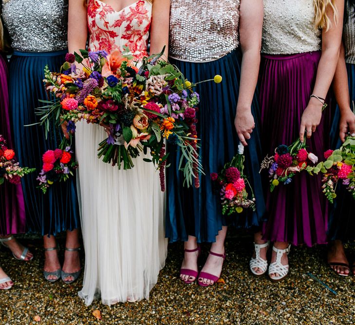 Oversized Bridal Bouquets | Bride in Red &amp; White Joanne Fleming Design Wedding Dress | Bridesmaids in Jewel Coloured Skirts &amp; Sequin Top Separates | Colourful Alternative Winter Wedding at Upwaltham Barns, Sussex | Epic Love Story Photography