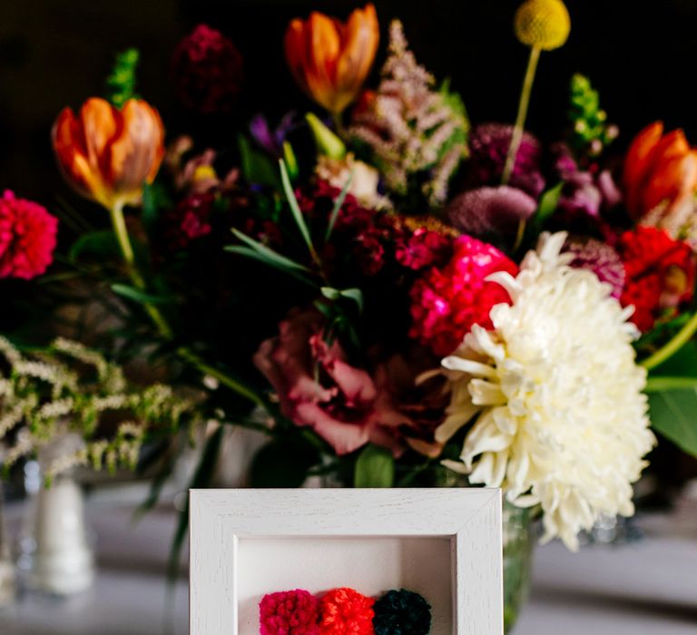 Pom Pom Table Number Sign | Colourful Alternative Winter Wedding at Upwaltham Barns, Sussex | Epic Love Story Photography