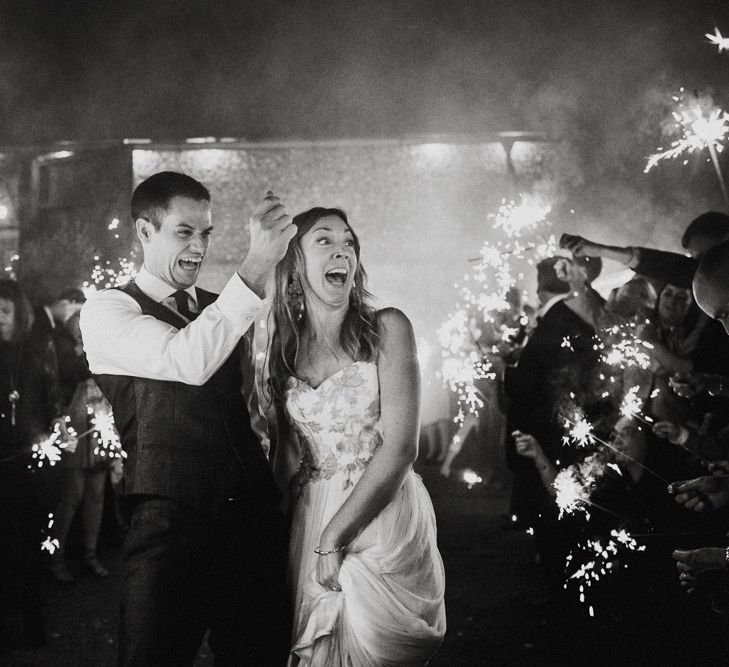 Sparkler Moment | Bride in Red &amp; White Joanne Fleming Design Wedding Dress | Groom in Suit Supply Suit | Colourful Alternative Winter Wedding at Upwaltham Barns, Sussex | Epic Love Story Photography