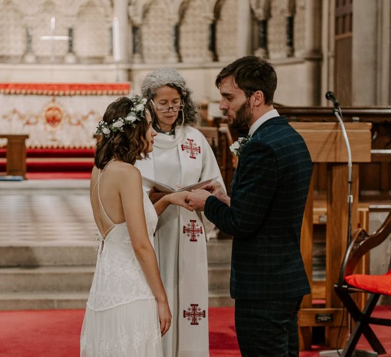 Bride and groom tie the knot at intimate church ceremony with bride wearing Spell And The Gypsy boho dress