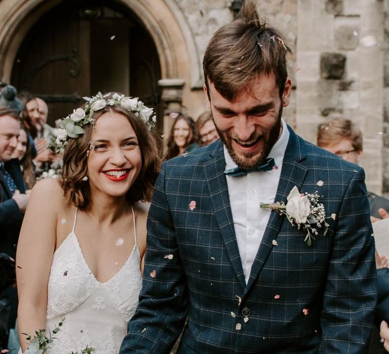 Church confetti shot with bride wearing Spell And The Gypsy boho dress teamed with a white floral crown and bouquet