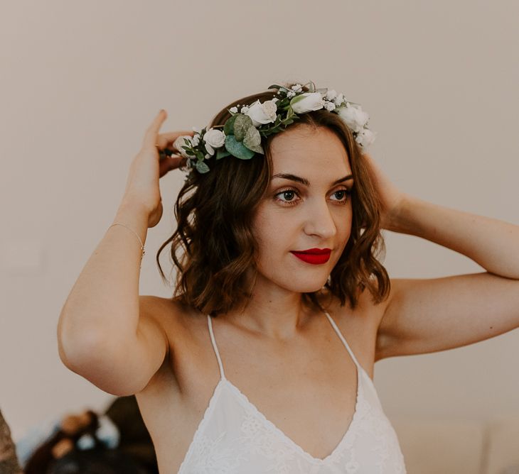 Bride wearing Spell And The Gypsy bridal dress with white floral flower crown and red lipstick