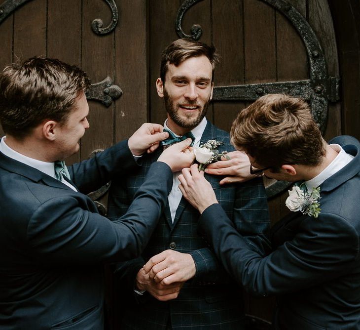 Groom and his groomsmen for intimate church ceremony