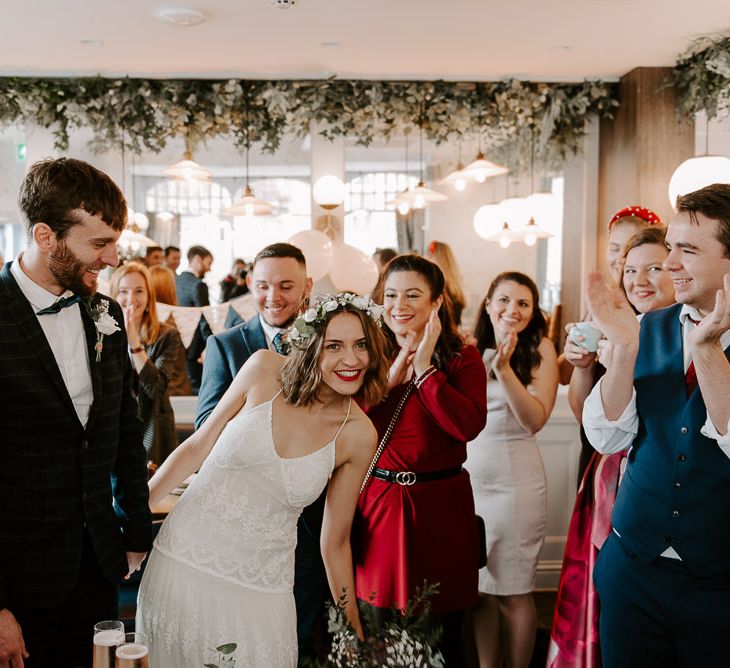 Bride and groom arrive at intimate wedding reception at Italian restaurant