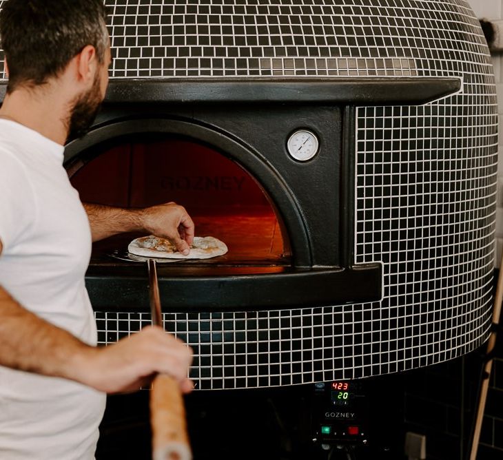 Pizza making at Italian restaurant for intimate reception in autumn