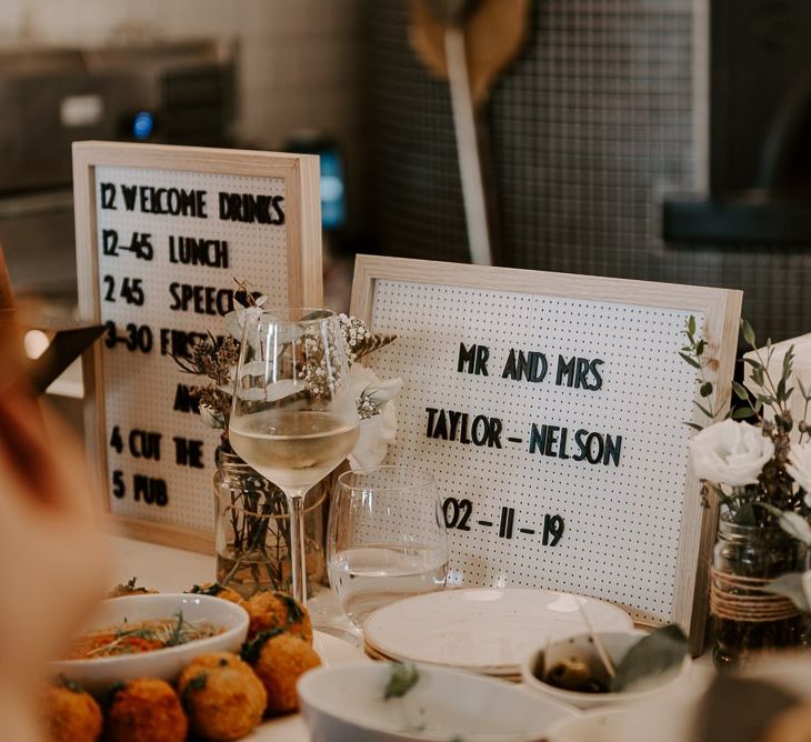 Wedding sign with white floral decor at Italian restaurant for intimate reception