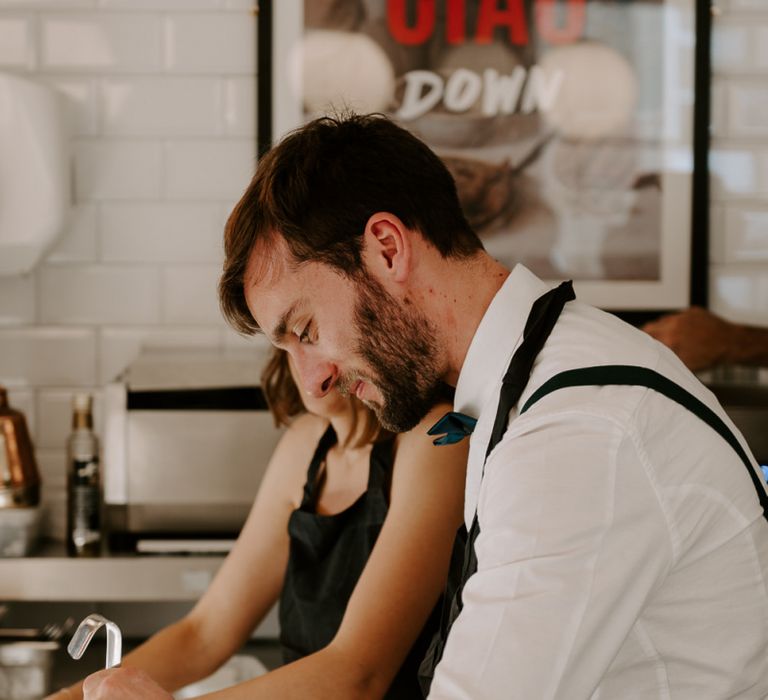 Bride and groom at Italian restaurant for intimate reception with pizza making and Aperol spritz cocktails