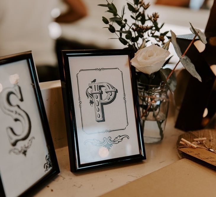 Black and white wedding stationery with white floral decor at intimate reception