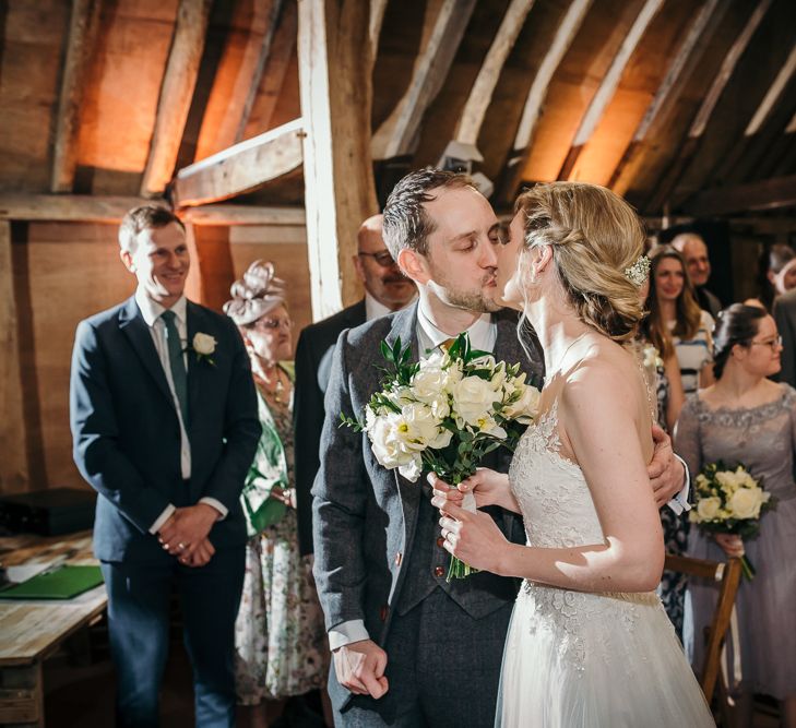 Wedding Ceremony | Bride in Essense of Australia Gown | Groom in  Grey Suit | Gold, Grey &amp; Green Rustic Wedding at The Gilbert White’s 16th Century Hampshire Barn | Joasis Photography