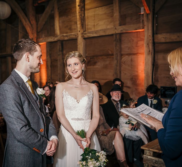 Wedding Ceremony | Bride in Essense of Australia Gown | Groom in  Grey Suit | Gold, Grey &amp; Green Rustic Wedding at The Gilbert White’s 16th Century Hampshire Barn | Joasis Photography