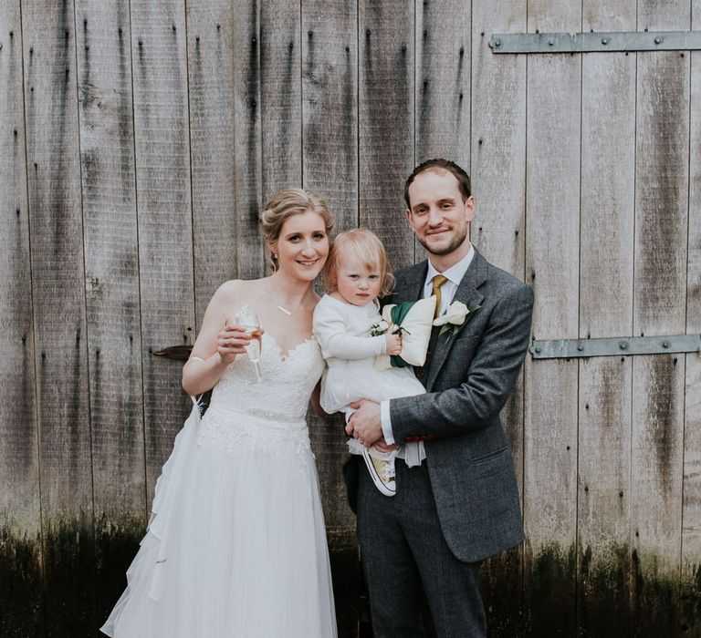 Family Portrait | Bride in Essense of Australia Gown | Groom in  Grey Suit | Gold, Grey &amp; Green Rustic Wedding at The Gilbert White’s 16th Century Hampshire Barn | Joasis Photography