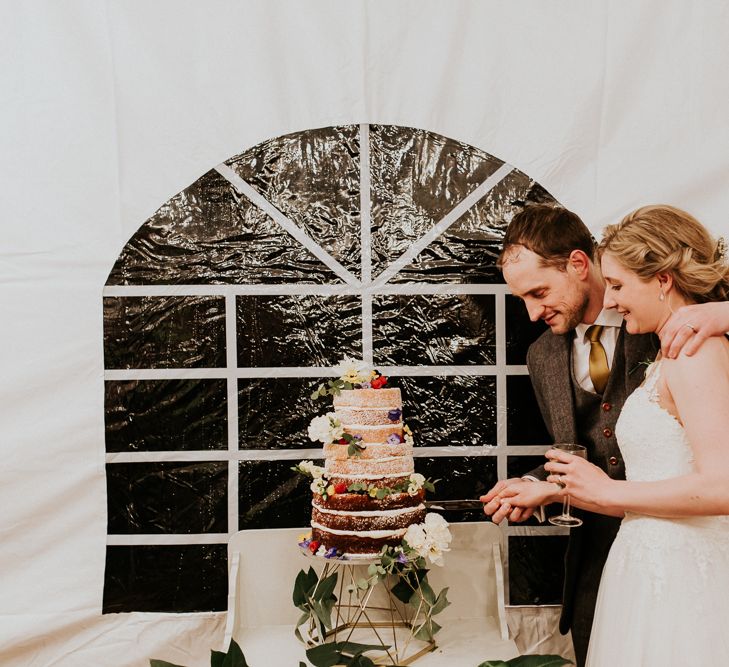 Bride &amp; Groom Cutting the Cake | Gold, Grey &amp; Green Rustic Wedding at The Gilbert White’s 16th Century Hampshire Barn | Joasis Photography