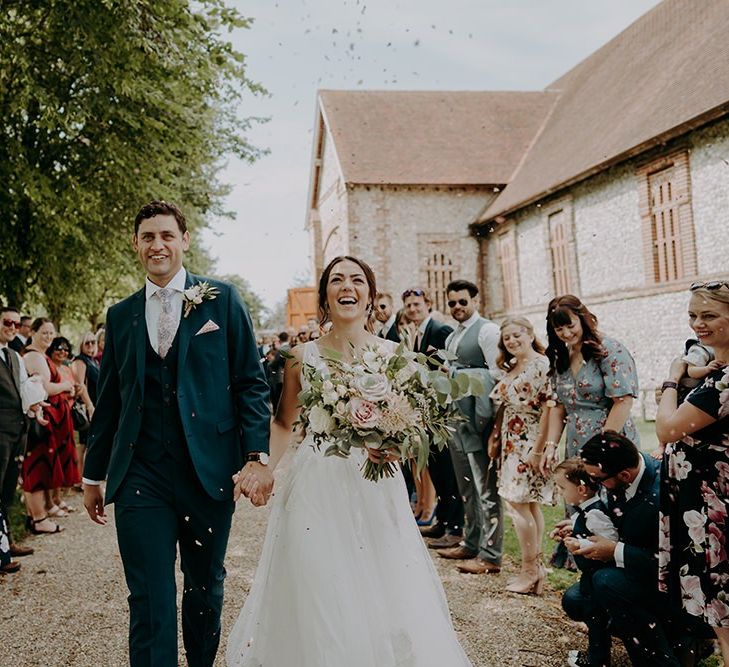 Confetti exit for bride and groom at Tithe Barn Petersfield