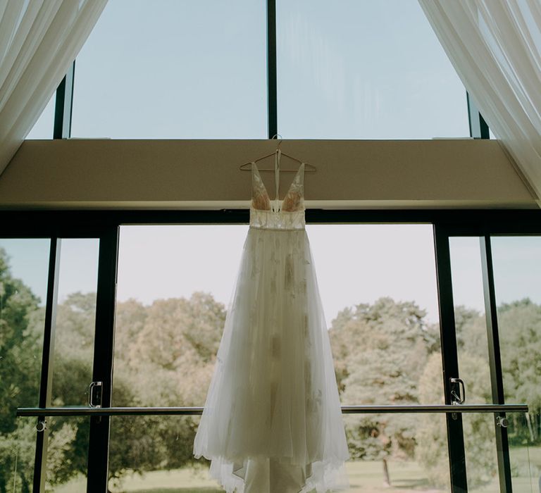 Willowby by Watters wedding dress hangs at Tithe Barn Petersfield