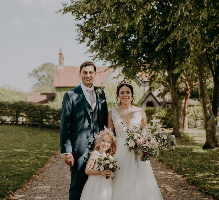 Bride and groom with flower girl at Tithe Barn Petersfield wedding