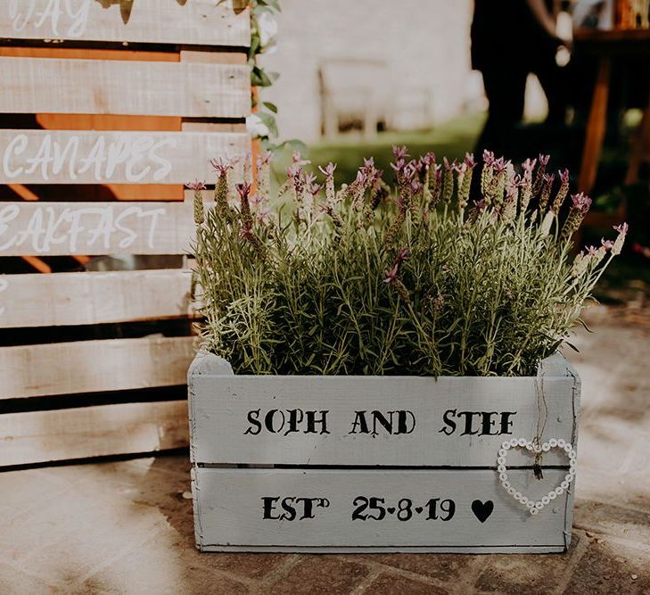 Personalised flower boxes for rustic barn wedding at Tithe Barn Petersfield