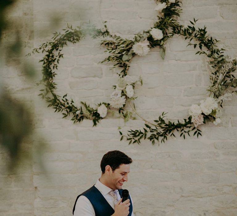 Groom wedding speech with hoop decor