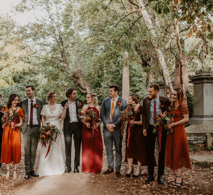 Wedding Party Portrait in the Cemetery with Autumn Leaves on the Floor