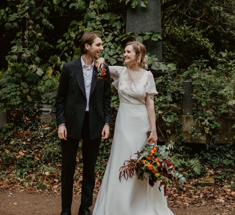 Bride in Story of My Dress Gown and Groom in  Black Suit