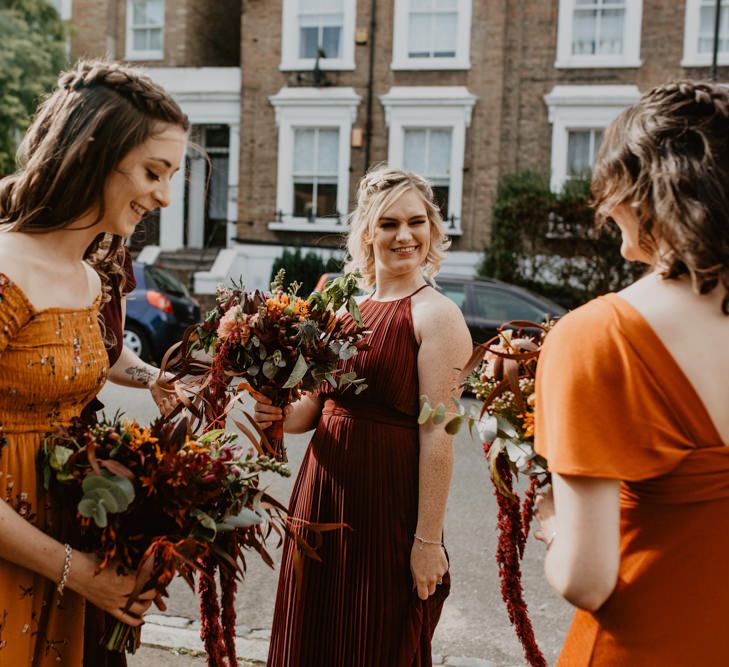 Bridesmaids in Different Burnt Orange Dresses