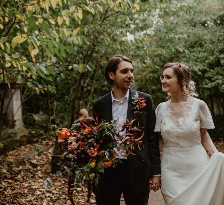 Bride and Groom Wedding Picture with Autumnal Leaves on the Floor