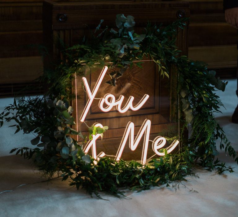 Neon You &amp; Me Sign at Altar | Town Hall Hotel Bethnal Green | Neon Sign and Marine Green Rewritten Bridesmaids Dresses with Lace Cape Grace Loves Lace Gown | Alain Mbouche Photography