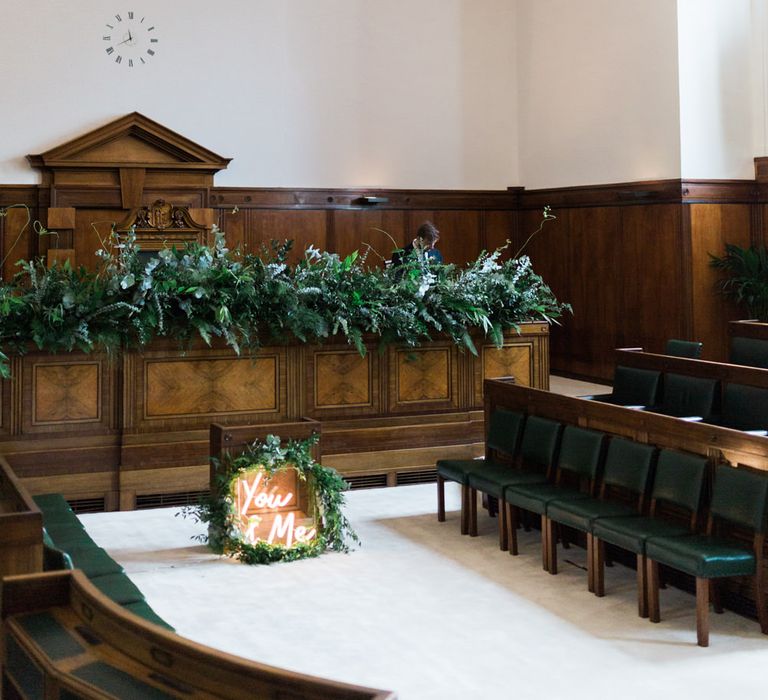 Neon You &amp; Me Sign at Altar | Town Hall Hotel Bethnal Green | Neon Sign and Marine Green Rewritten Bridesmaids Dresses with Lace Cape Grace Loves Lace Gown | Alain Mbouche Photography