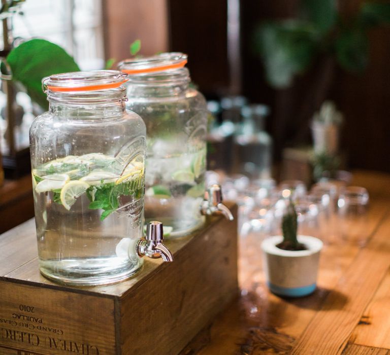 Large Kilner Jars | Upturned Wooden Wine Box | Industrial Photographic Floor Lamp | Neon Sign and Marine Green Rewritten Bridesmaids Dresses with Lace Cape Grace Loves Lace Gown | Alain Mbouche Photography