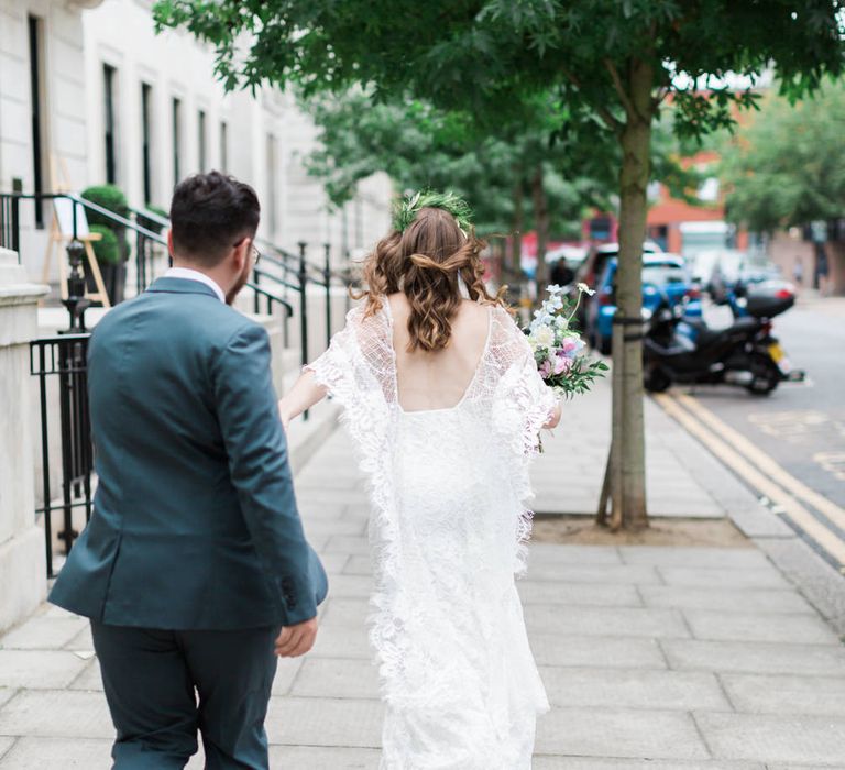 Bride in Grace Loves Lace Verdelle Dress with V-Neck, Low Square Back, Mid-Thigh Front Split and Lace Cape | Foliage Hair Crown | Gold Flat Gianvito Rossi Sandals | Pastel Bridal Bouquet | Groom in Blue Reiss Suit with Brown Grenson Shoes | Neon Sign and Marine Green Rewritten Bridesmaids Dresses with Lace Cape Grace Loves Lace Gown | Alain Mbouche Photography