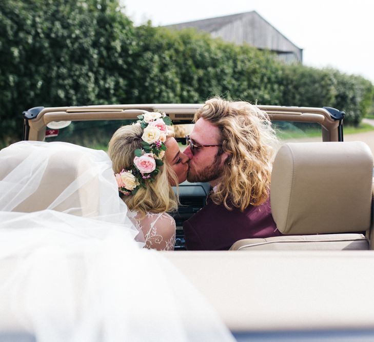 Bride and Groom Kissing in the Wedding Car