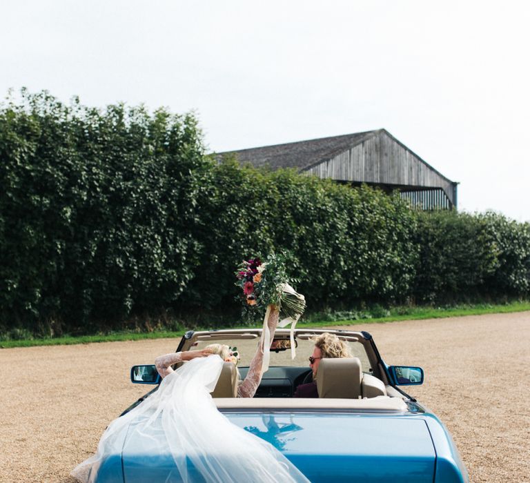 Bride and Groom Driving in the Wedding Car